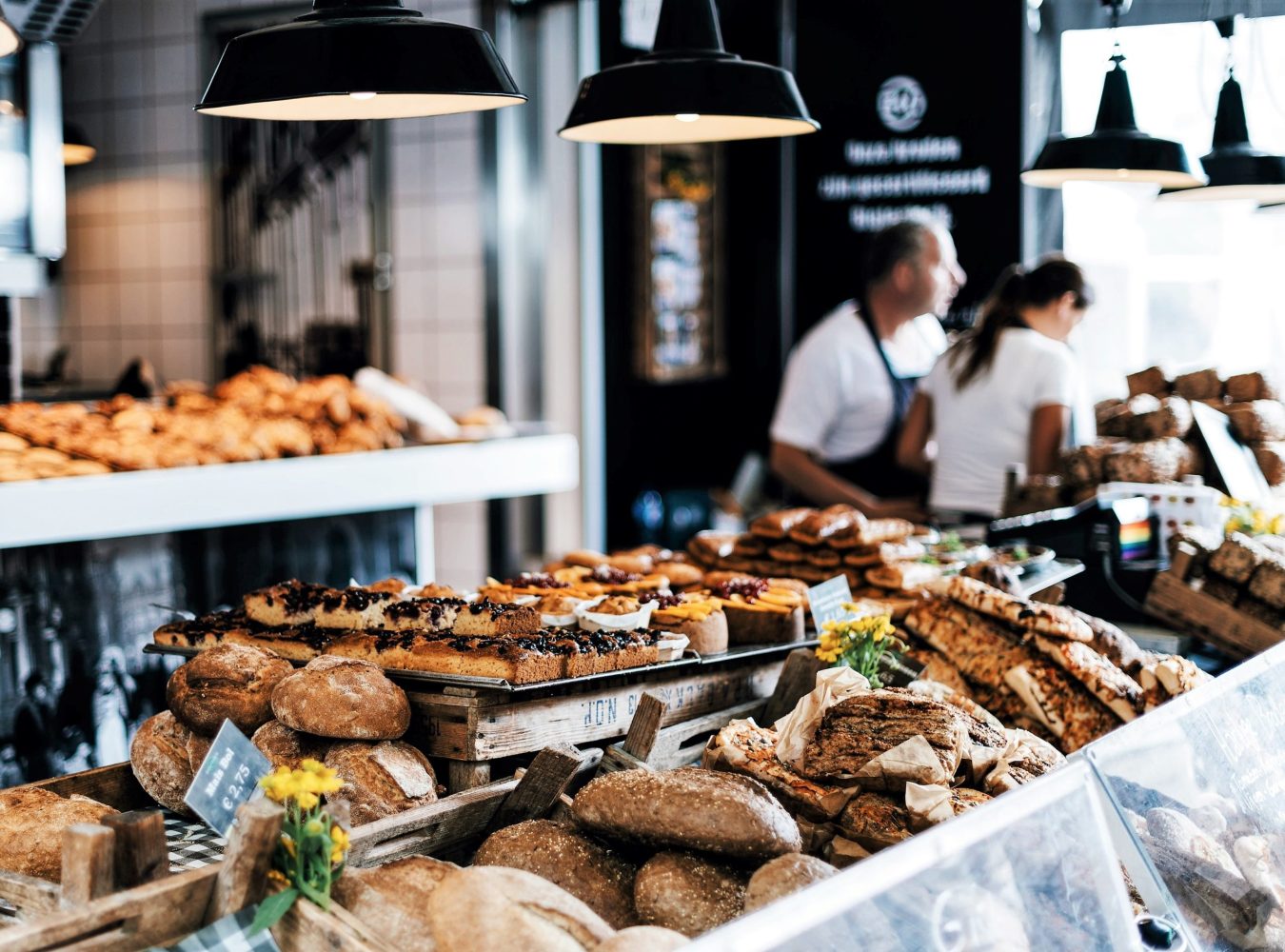 a group of people preparing food in a store