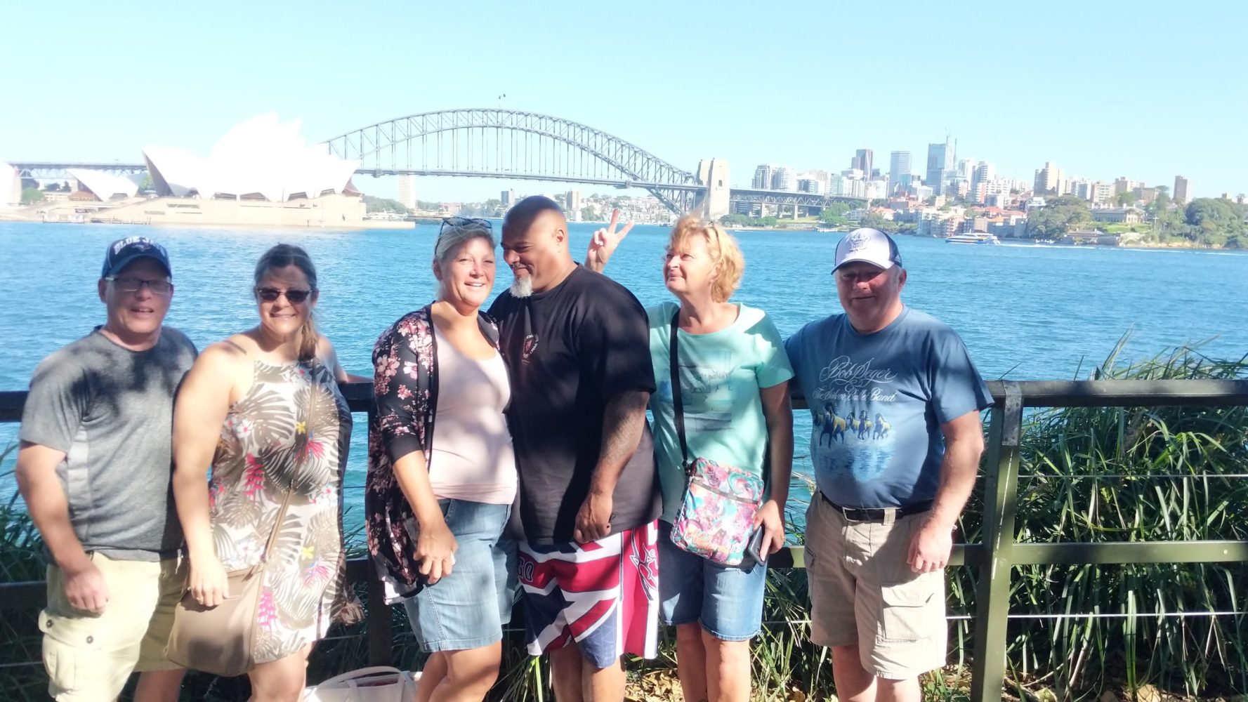 a group of people standing in front of a body of water