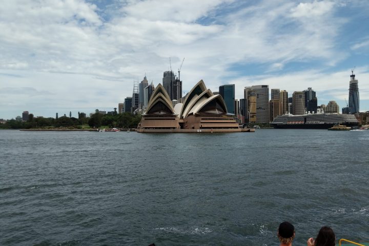 a group of people standing next to a body of water