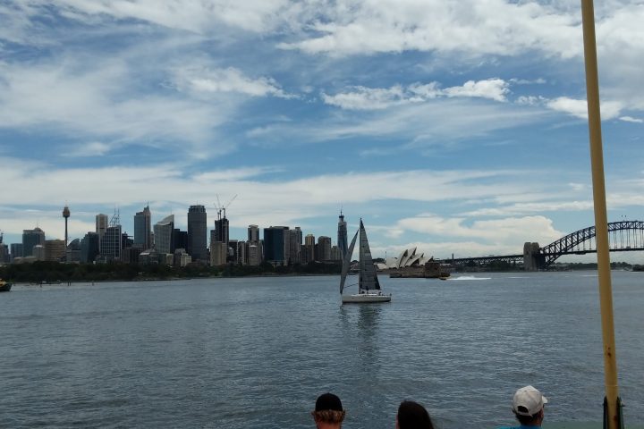 a group of people standing in front of a body of water