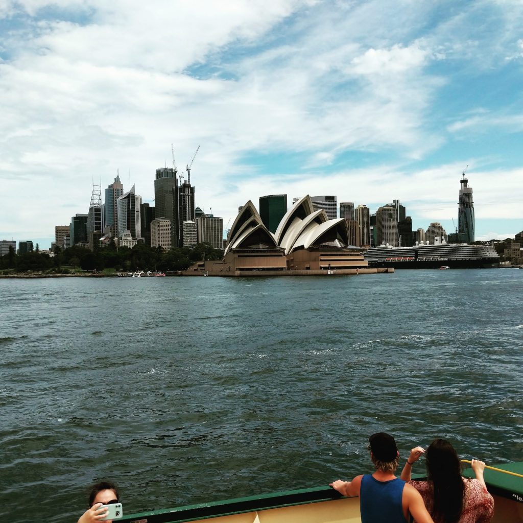 a group of people standing next to a body of water