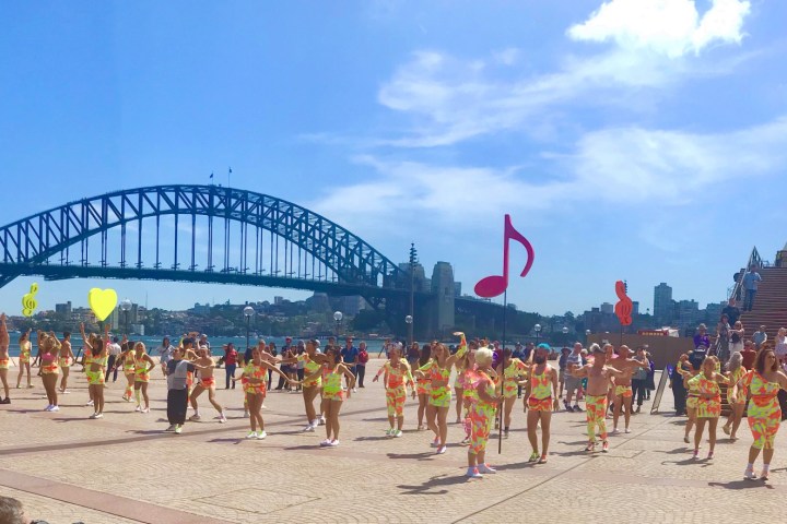 a group of people on a beach posing for the camera