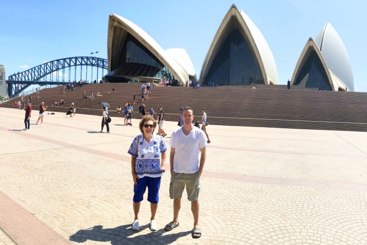 a group of people standing on a beach