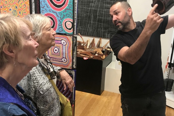 a group of people looking at a cell phone