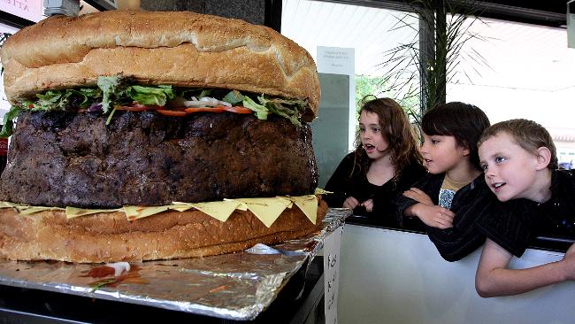 e9d9e68fbbe794e040424867c827bda6 a cut in half sandwich sitting on top of a table