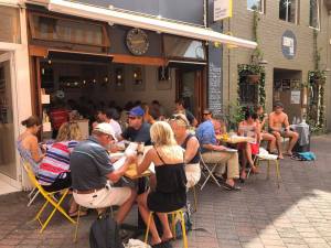 a group of people sitting in front of a building