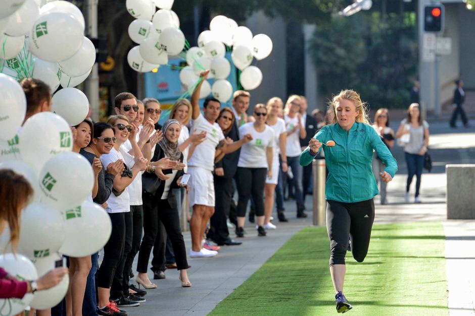 213569-1_fastest_100_meters_egg_and_spoon_race_Sally_Pearson a group of people standing in front of a crowd
