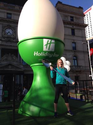 a woman standing in front of a green building