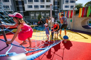 a woman sitting next to a fence
