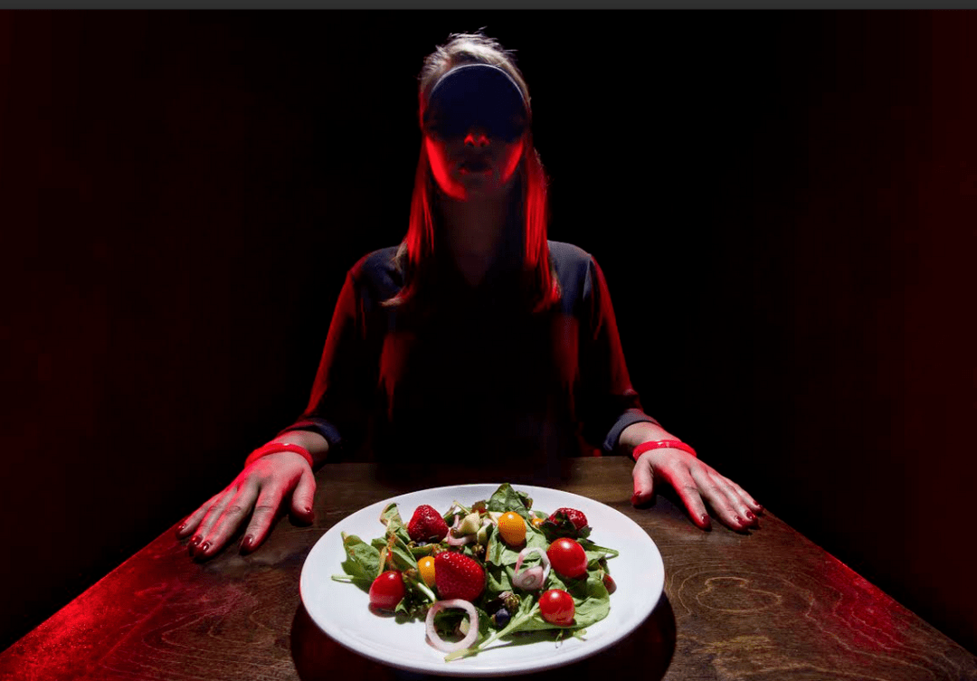 a person sitting at a table with a plate of food