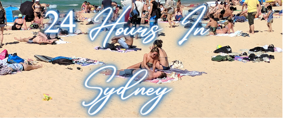 Manly Beach a group of people lying on a sandy beach