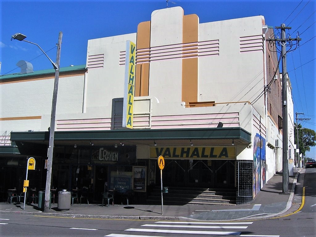 2691449 a building that has a sign on the side of a road