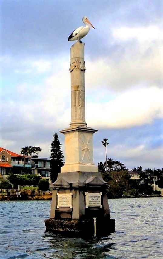 Searle monument1_Fotor a small clock tower next to a body of water