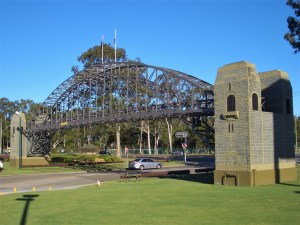 a clock tower on top of a grass covered field