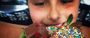 a close up of a girl holding a piece of cake