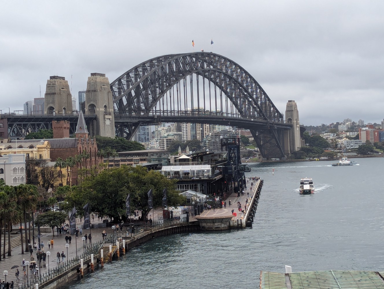 a group of people on a bridge over a body of water